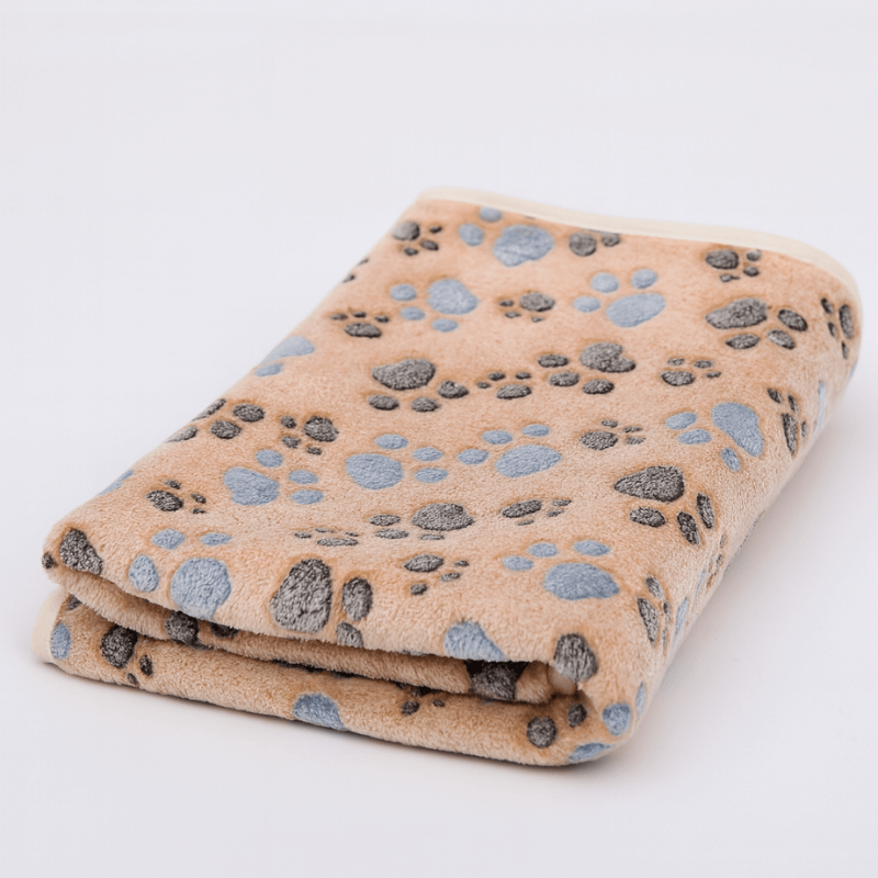 Folded blanket with paw print pattern on a white background